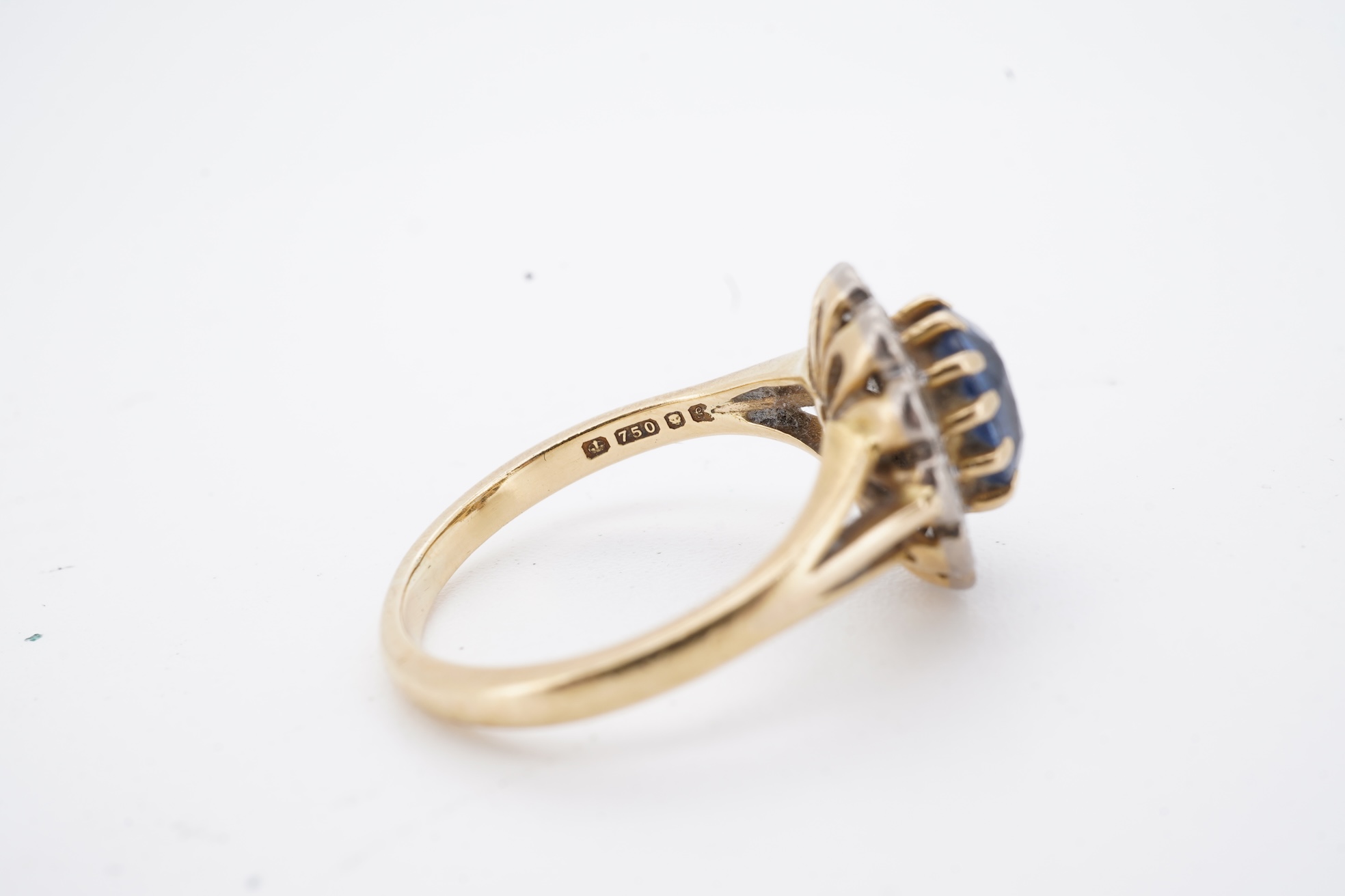 A 1980's 18ct gold, sapphire and diamond set oval cluster ring, size K, gross weight 3.8 grams.